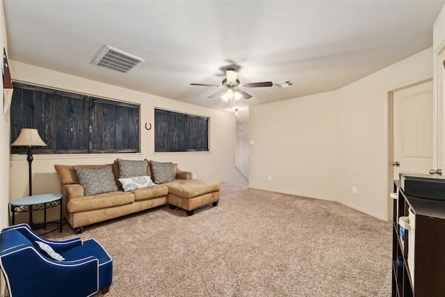 living room featuring ceiling fan and carpet