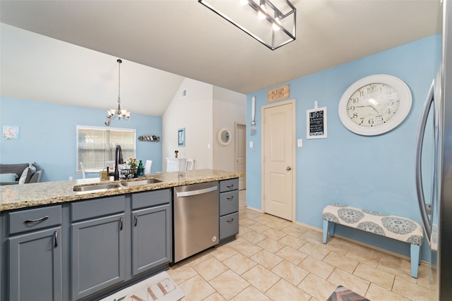 kitchen with stainless steel appliances, vaulted ceiling, sink, an inviting chandelier, and hanging light fixtures