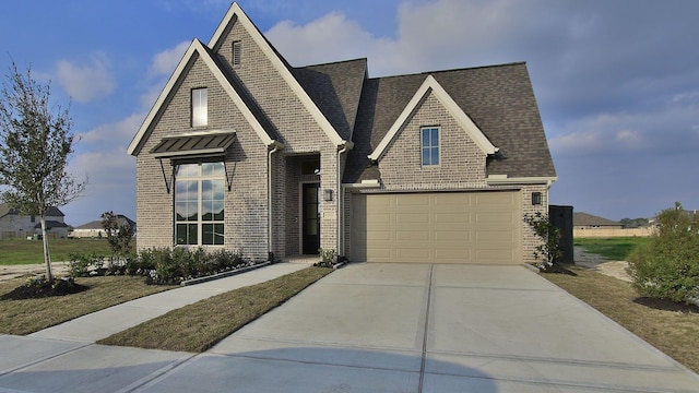 view of front facade featuring driveway, a shingled roof, a garage, and brick siding