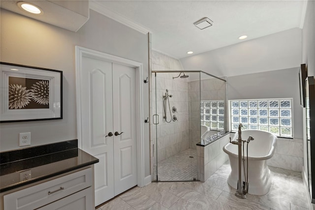 bathroom with vanity, ornamental molding, and independent shower and bath