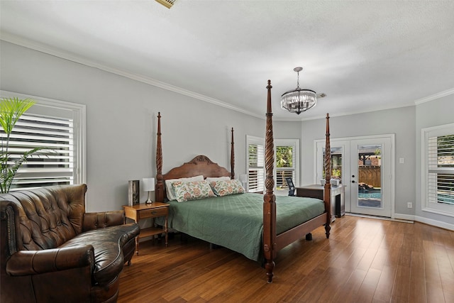 bedroom with access to outside, french doors, ornamental molding, dark hardwood / wood-style flooring, and a chandelier