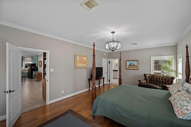 bedroom featuring hardwood / wood-style floors, refrigerator, crown molding, and a chandelier