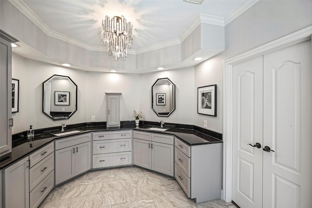 bathroom featuring vanity, an inviting chandelier, and ornamental molding