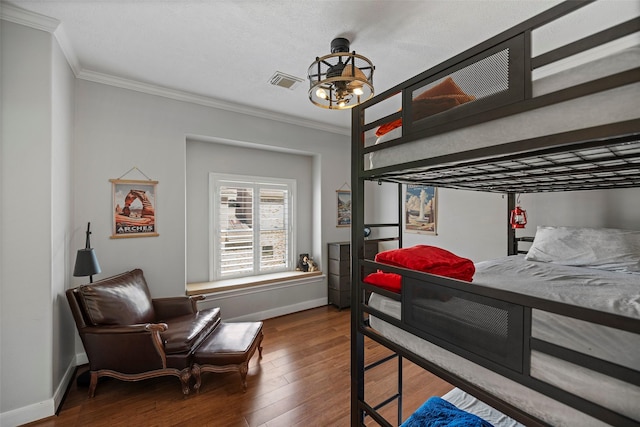 bedroom with wood-type flooring and ornamental molding