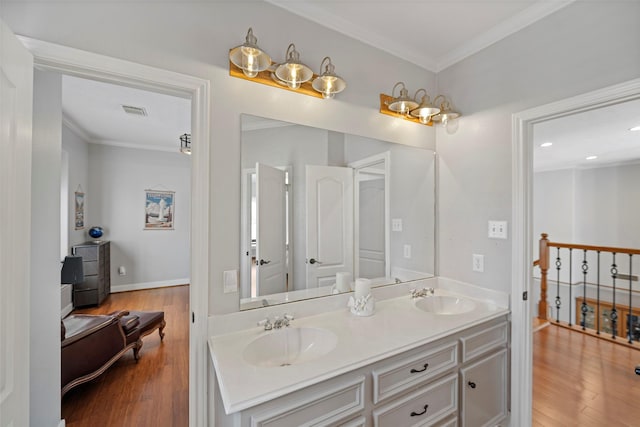 bathroom with hardwood / wood-style floors, vanity, and ornamental molding