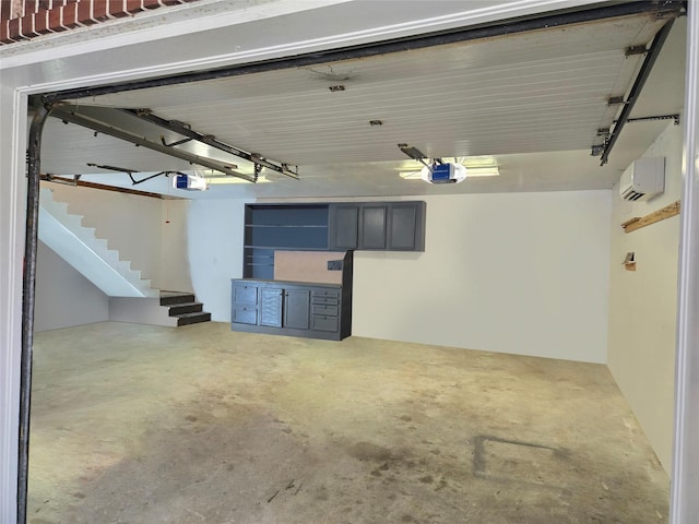 garage featuring a wall unit AC and a garage door opener