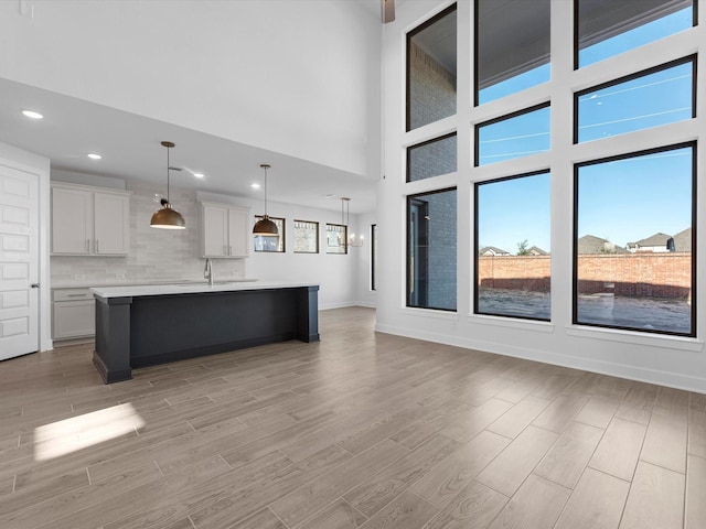 unfurnished living room with sink and a high ceiling