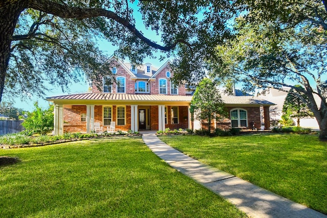 view of front facade with covered porch and a front lawn