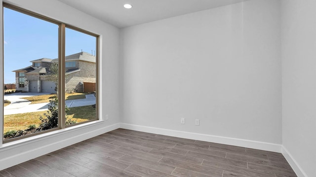 empty room with hardwood / wood-style flooring