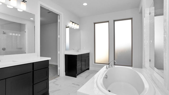 bathroom with independent shower and bath and vanity