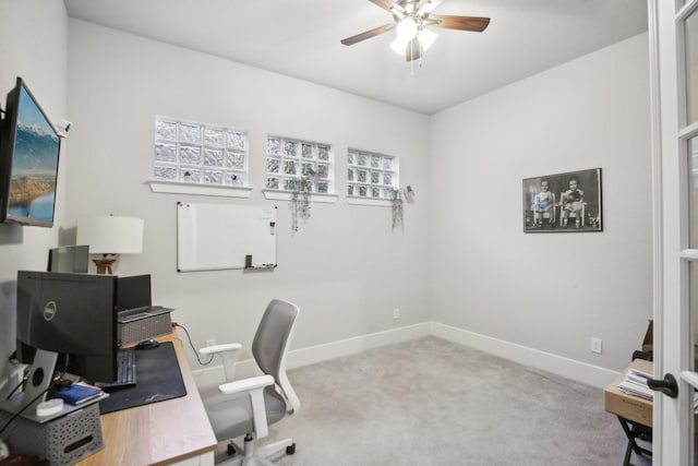 carpeted office space with ceiling fan