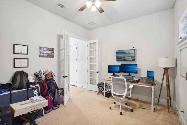 carpeted office space with french doors and ceiling fan