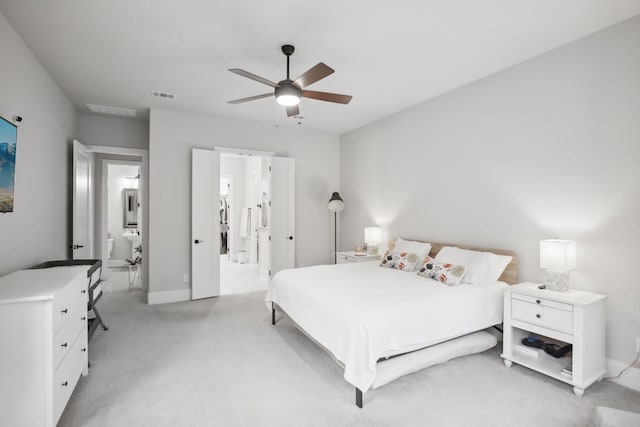 carpeted bedroom featuring ceiling fan and ensuite bathroom