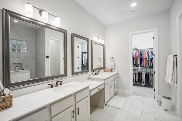 bathroom featuring vanity and tiled shower