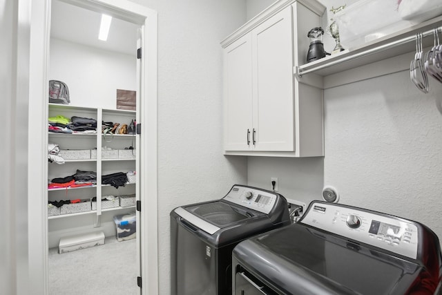 laundry area with cabinets, independent washer and dryer, and carpet flooring