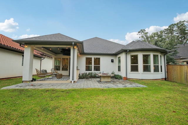 rear view of house featuring a patio and a lawn