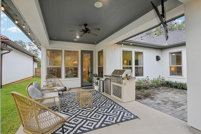 view of patio featuring area for grilling, ceiling fan, and a grill