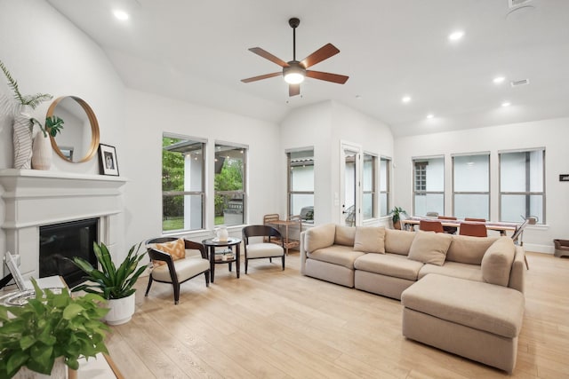 living room featuring light wood-type flooring, ceiling fan, and lofted ceiling