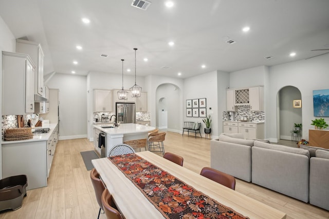 living room with light hardwood / wood-style floors and sink