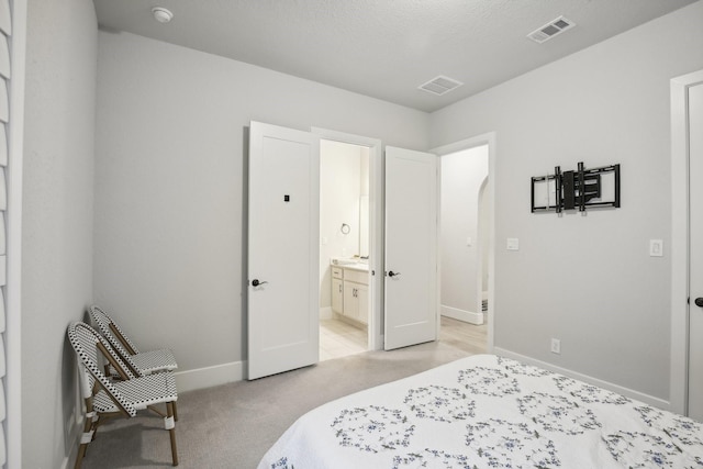 carpeted bedroom with ensuite bathroom