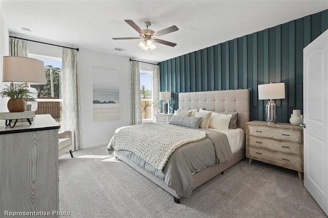 bedroom featuring light carpet and ceiling fan