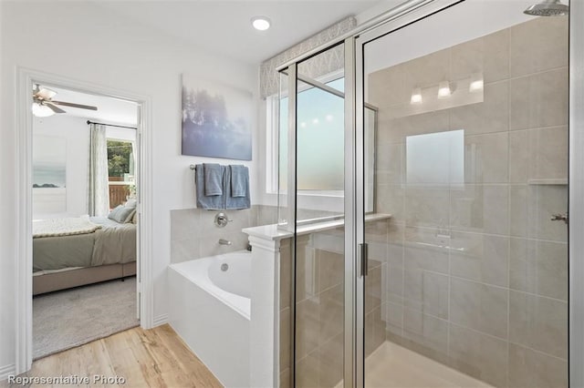 bathroom with hardwood / wood-style flooring, ceiling fan, and independent shower and bath