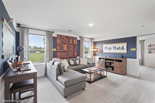 carpeted living room with plenty of natural light