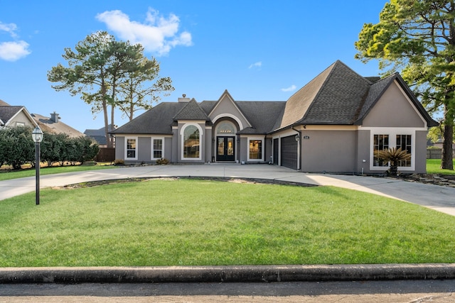 french provincial home featuring a garage and a front yard