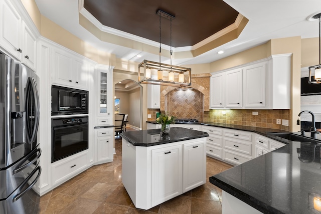 kitchen featuring white cabinets, sink, black appliances, and decorative light fixtures