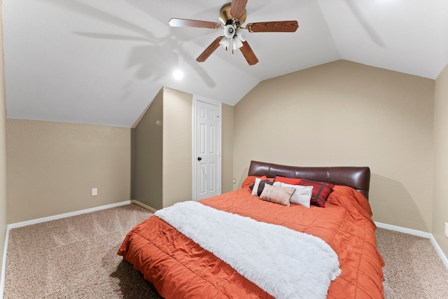 carpeted bedroom with ceiling fan and vaulted ceiling