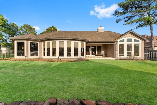 back of property with a yard and a patio area