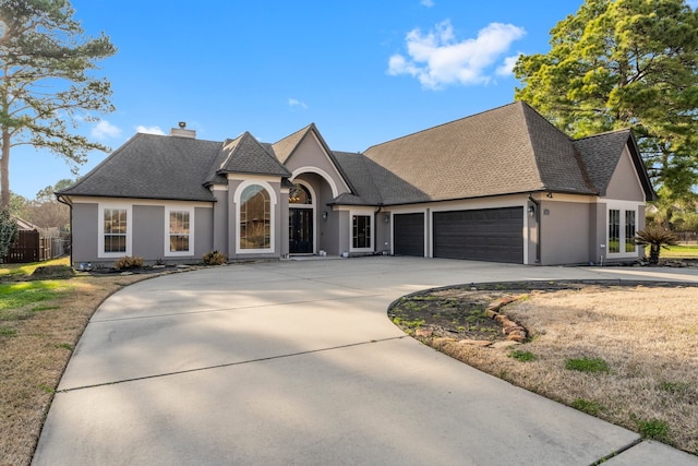 french country style house with a garage