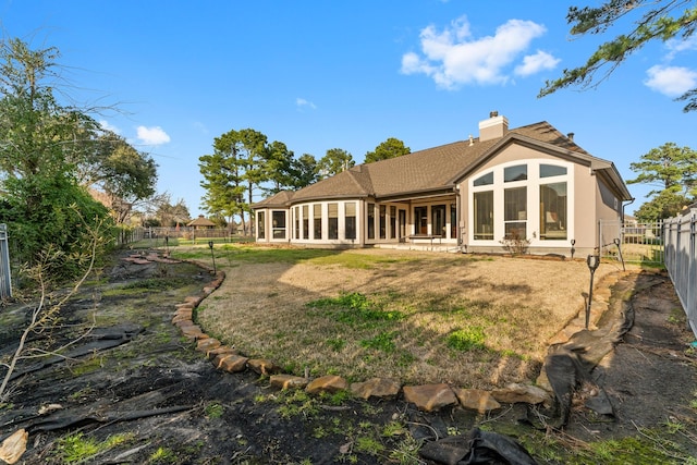 back of house featuring a yard