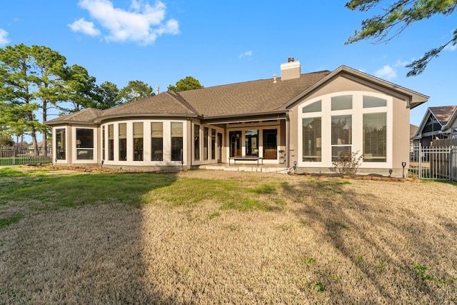 back of house featuring a patio area, a sunroom, and a yard