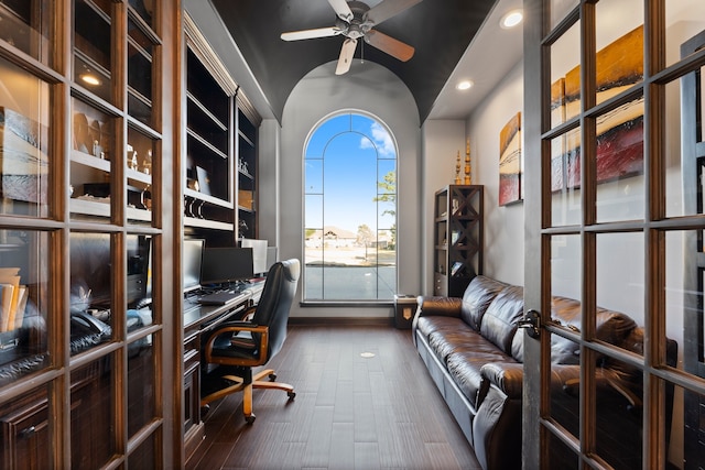 unfurnished office featuring dark hardwood / wood-style flooring, ceiling fan, and vaulted ceiling