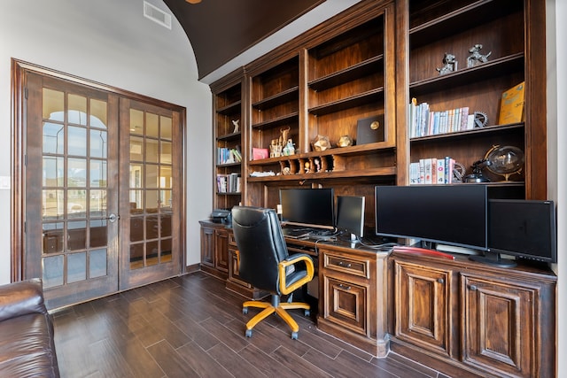 office area featuring vaulted ceiling, built in desk, dark hardwood / wood-style floors, and french doors