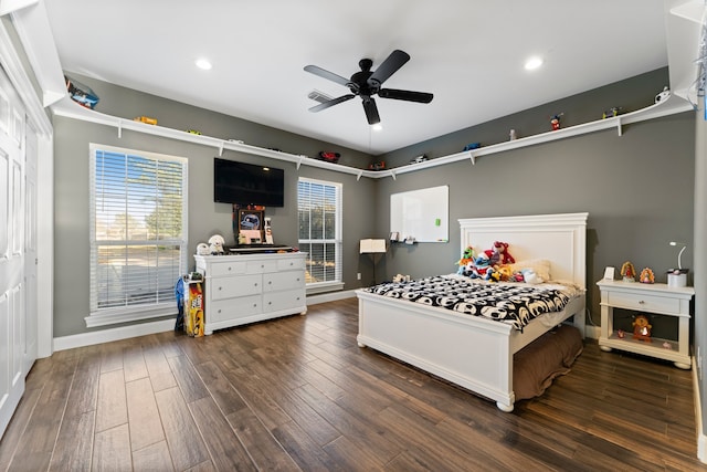 bedroom featuring dark wood-type flooring, ceiling fan, and multiple windows