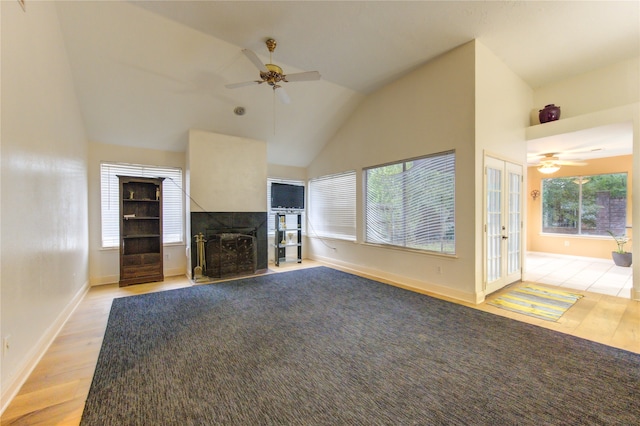 unfurnished living room featuring ceiling fan, vaulted ceiling, and light hardwood / wood-style floors