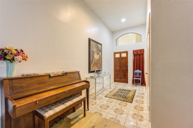 entrance foyer with a towering ceiling and light hardwood / wood-style flooring