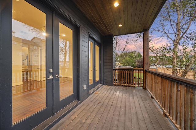 deck at dusk featuring french doors