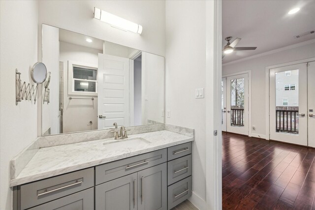 bathroom featuring wood-type flooring, vanity, french doors, ceiling fan, and crown molding