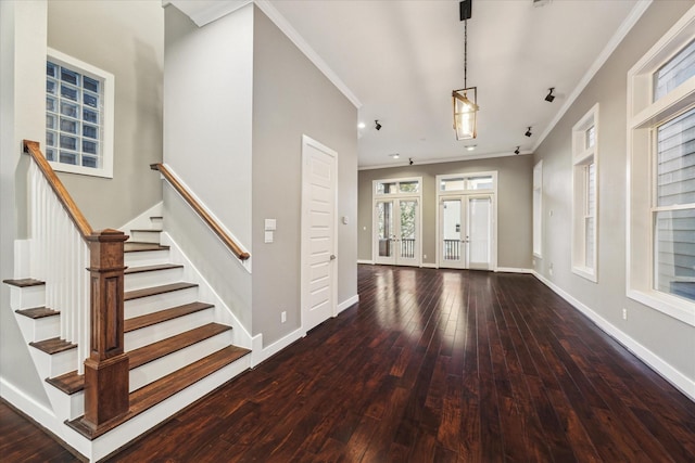 foyer featuring french doors, ornamental molding, and dark wood-type flooring