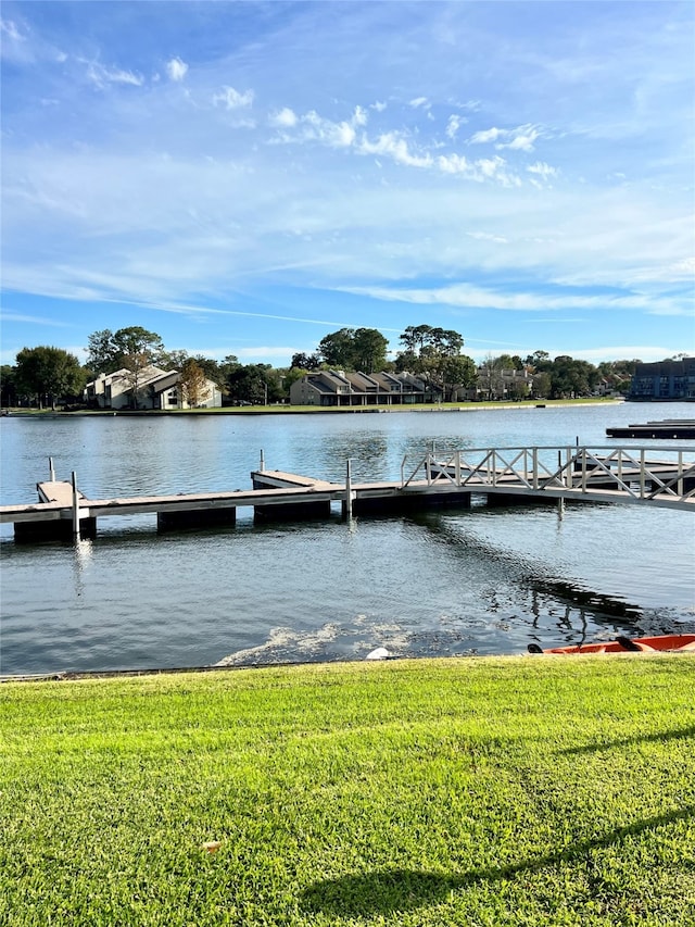 dock area featuring a water view and a yard