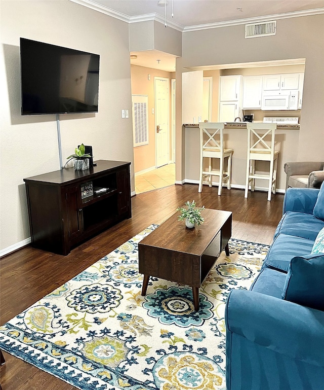 living room with dark hardwood / wood-style flooring and crown molding