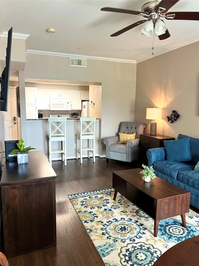 living room featuring ceiling fan, dark hardwood / wood-style floors, and ornamental molding