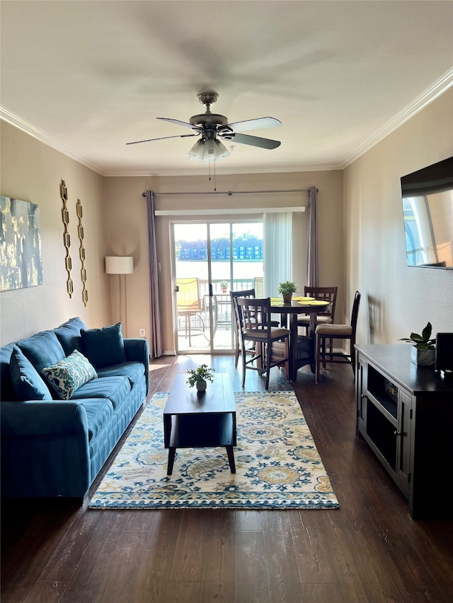 living room featuring ceiling fan, dark hardwood / wood-style floors, and crown molding