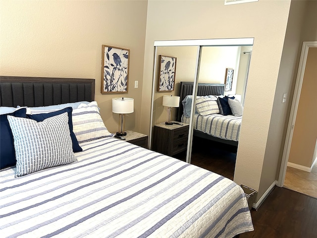 bedroom featuring dark hardwood / wood-style floors and a closet