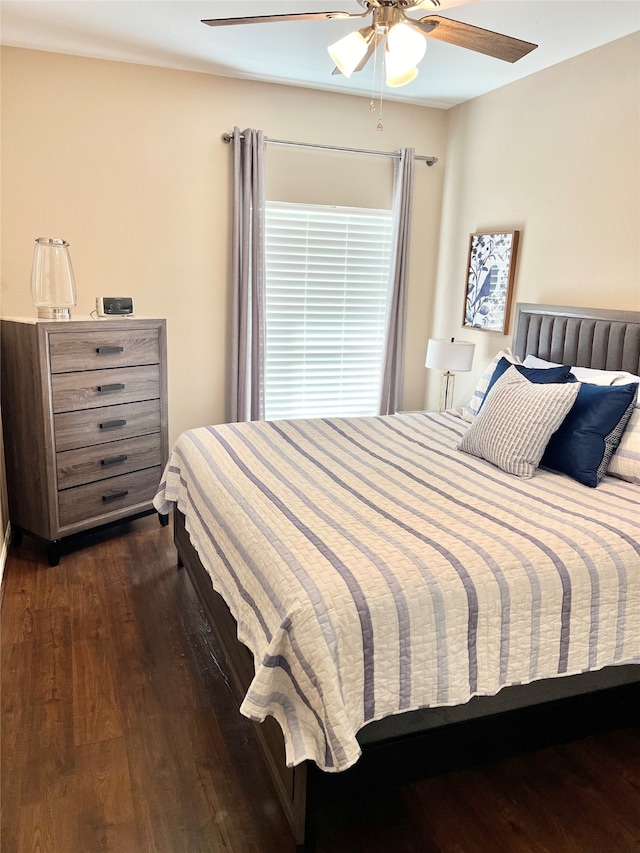 bedroom with ceiling fan and dark hardwood / wood-style flooring