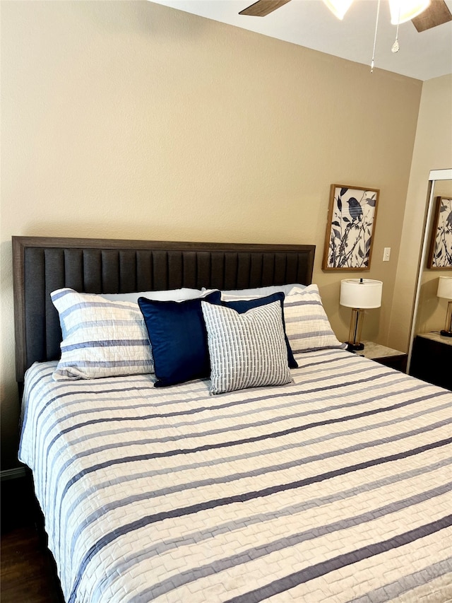 bedroom with hardwood / wood-style floors and ceiling fan