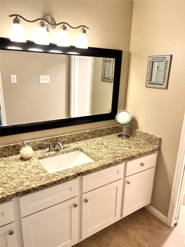 bathroom with tile patterned flooring and vanity